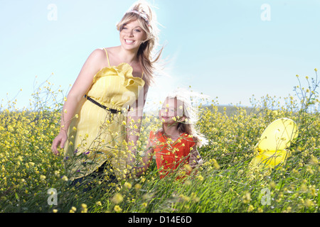 Sisters playing in field of flowers Stock Photo