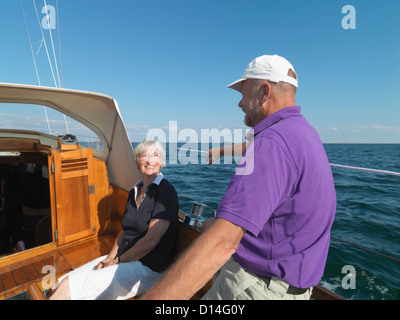 Older couple sailing together on ocean Stock Photo