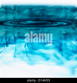 Blue ink swirling in liquid Stock Photo