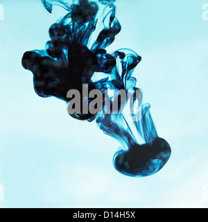 Blue ink swirling in liquid Stock Photo