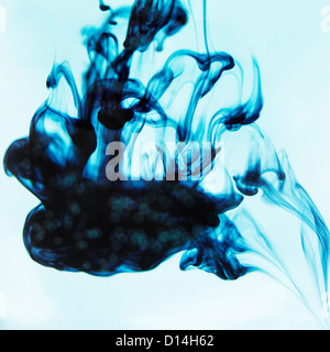 Blue ink swirling in liquid Stock Photo