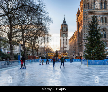 People skating on the temporary ice rink at the Natural History Museum, South Kensington, London Stock Photo