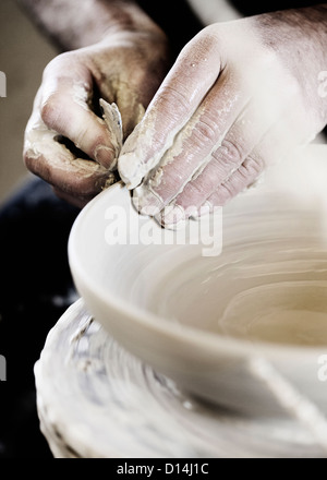 Potter creating handcrafted bowl in shop Stock Photo
