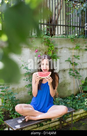 Smiling woman eating watermelon Stock Photo