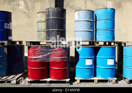 Drums of liquid on wooden pallets Stock Photo