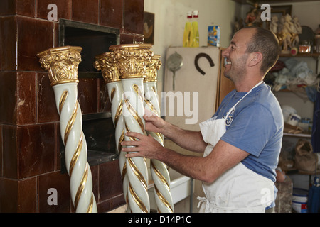 Worker admiring decorative poles Stock Photo