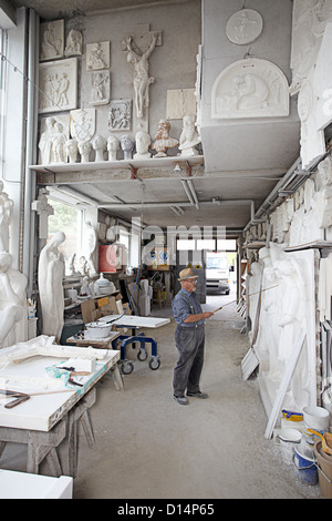 Worker standing in relief carving shop Stock Photo