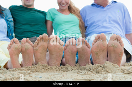 Close up of sandy feet on beach Stock Photo