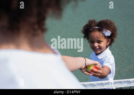 Mother and daughter playing on court Stock Photo