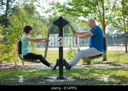 Older couple using exercise equipment Stock Photo