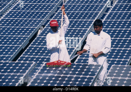 India Rajasthan, men clean solar panel in Brahma Kumari Ashram in Mt. Abu, solar modules a used for own power generation Stock Photo