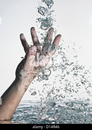 Closeup image of a hand splashing water in the pool Stock Photo - Alamy