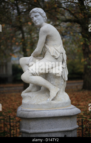 Stone statue of a boy on a drinking fountain in St. James's Park. Stock Photo