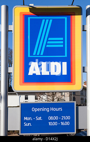 Aldi supermarket sign with opening hours, Abergavenny, Wales, UK Stock Photo