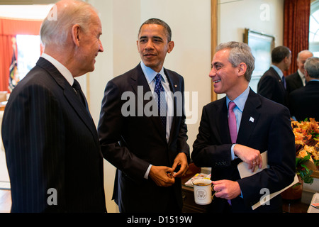 US President Barack Obama and Vice President Joe Biden talk with Chicago Mayor Rahm Emanuel in the Outer Oval Office November 16, 2012 in Washington, DC. Stock Photo