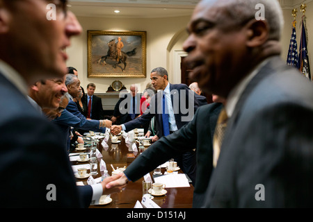 US President Barack Obama shakes hands with civic and constituency leaders to during a meeting in the Roosevelt Room of the White House November 16, 2012 in Washington, DC. Stock Photo