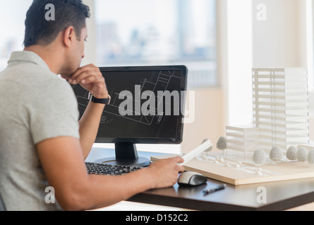 USA, New Jersey, Jersey City, Businessman working on computer in office Stock Photo