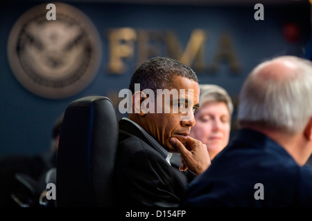 US President Barack Obama receives a briefing on the ongoing response to Hurricane Sandy at FEMA headquarters November 3, 2012 in Washington, DC. Stock Photo