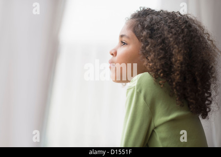 USA, New Jersey, Jersey City, Girl (6-7) looking through window Stock Photo