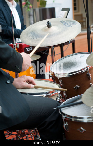 A jazz band on stage including a drummer and a keyboard player Stock Photo