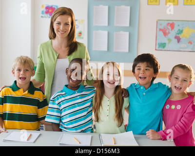 USA, New Jersey, Jersey City, School children (8-9) with female teacher in classroom Stock Photo