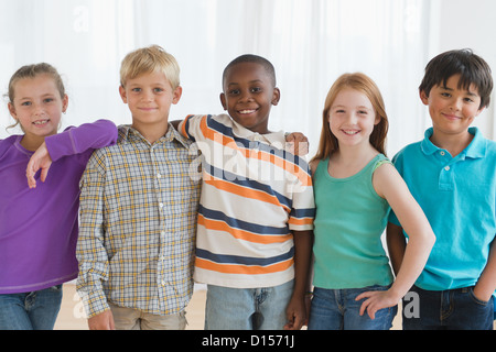 USA, New Jersey, Jersey City, School children (8-9) sitting in row with open books Stock Photo