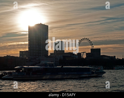 Sunset view of Thames Clippers on the River Thames showing the London Eye in background, Victoria Embankment, City of London. Stock Photo