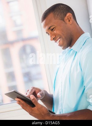 Young man using digital tablet Stock Photo