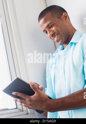 Young man using digital tablet Stock Photo