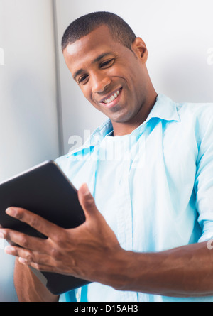 Young man using digital tablet Stock Photo