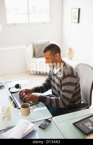 USA, New Jersey, Jersey City, Young man working from home Stock Photo