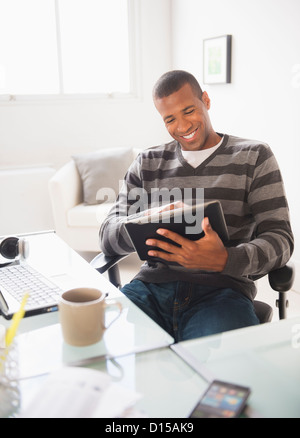 USA, New Jersey, Jersey City, Young man working from home Stock Photo