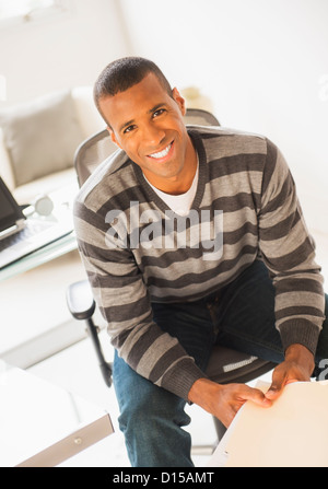 USA, New Jersey, Jersey City, Portrait of young man in striped sweater Stock Photo