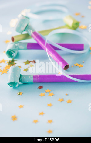 Studio shot of party blowers and confetti Stock Photo - Alamy
