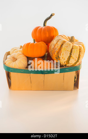 Basket full of pumpkins Stock Photo - Alamy