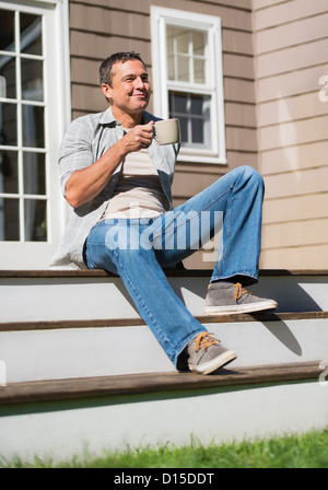 USA, New Jersey, Mendham, Portrait of man sitting on steps Stock Photo