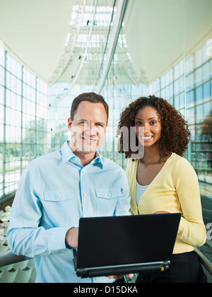 USA, Utah, Salt Lake City, Man and woman using laptop Stock Photo