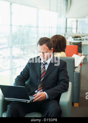 USA, Utah, Salt Lake City, Man using laptop while waiting in lobby Stock Photo