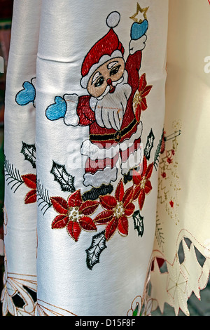 White and yellow tablecloths for Christmas dinner party, embroidered with various specific ornaments. Stock Photo