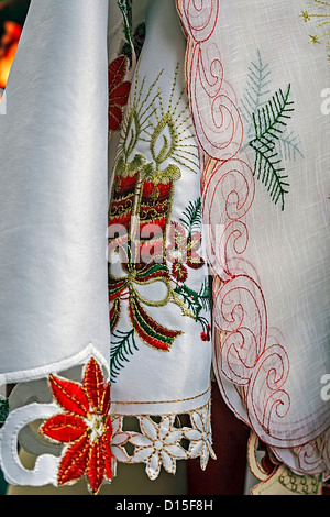 White tablecloths for Christmas dinner party, embroidered with various specific ornaments. Stock Photo