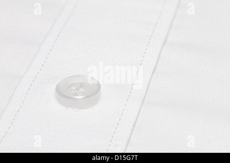 Close up image of white button on formal white cotton shirt Stock Photo