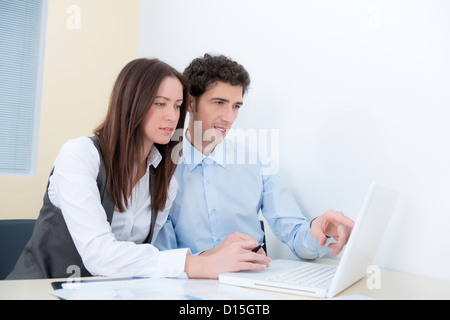 A business team are planning and discuss the project with a modern laptop. Stock Photo