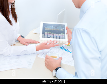 Businessman getting advice from a financial analyst. Stock Photo