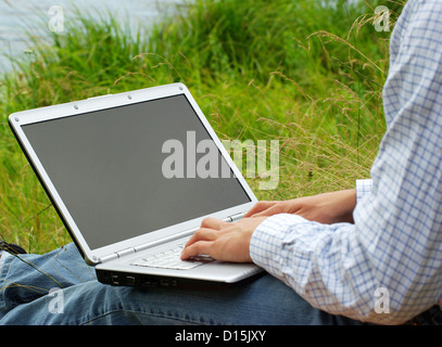 male hands typing on a laptop Stock Photo