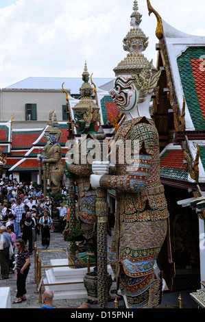 Grand Palace Bangkok Thailand Wat Phra Kaew Temple of the Emerald Buddha giant mythological yak demons stand standing guard Stock Photo