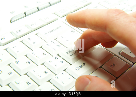 male hands typing on a white computer keyboard Stock Photo