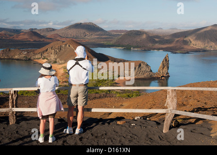 Tourists view volcanic landscape from top of Isla Bartolome, Galapagos Islands, Ecuador Stock Photo