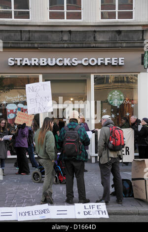 Exeter, UK, Saturday 8th December 2012. Protesters picket Starbucks Coffee Shop in Exeter High Street over the company's tax avoidance practices. Alamy Live News Stock Photo