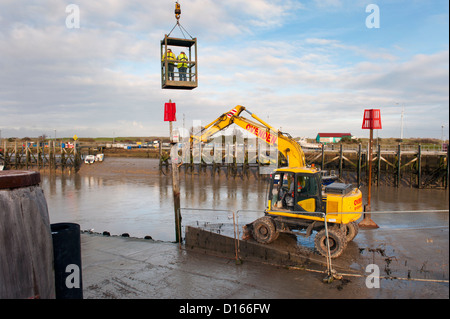 Works on the wharf infrastructure and the River Rother Tidal Walls sea flood defences, Rye Harbour, Sussex. Stock Photo