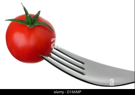 cherry tomato on a fork against a white background Stock Photo